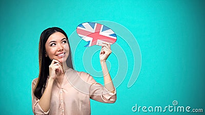 Curious woman holding British flag sign, learning language, education abroad Stock Photo