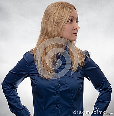 Curious young woman in casual blue shirt looking right Stock Photo