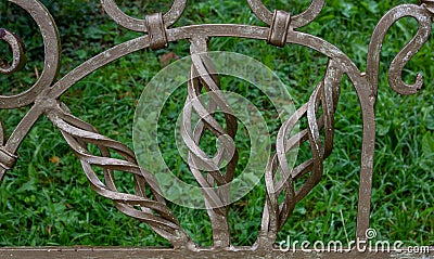 Curlicues on a wrought-iron Park bench. Garden furniture bench Stock Photo