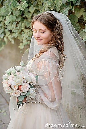 Curls cover shoulders of pretty bride Stock Photo