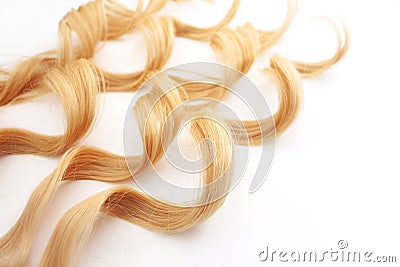 Curls curled on the Curling iron, isolated on white background. strand of blonde hair, hair care Stock Photo