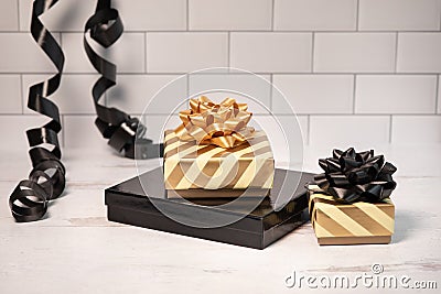 Black and gold ribbon and bows small wrapped gifts Stock Photo