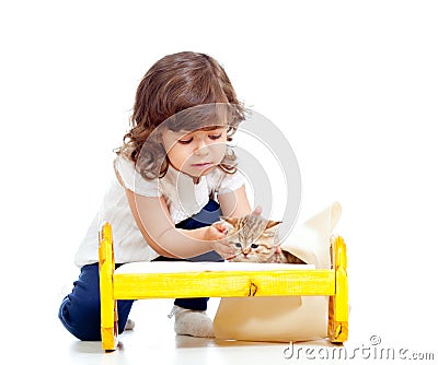 Curly child girl playing with kitten Stock Photo