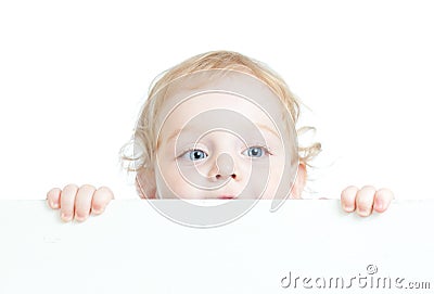 Curly cute child holding blank advertising banner Stock Photo