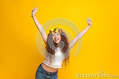 Curly haired girl wearing chaplet cheering Stock Photo