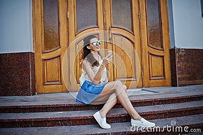 Curly stylish girl wear on blue jeans skirt Stock Photo