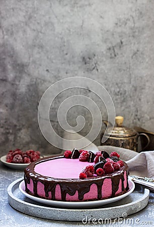 Currant mousse cake decorated with pieces of cookies and raspberries Stock Photo