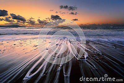 Current lines on shore stones Stock Photo