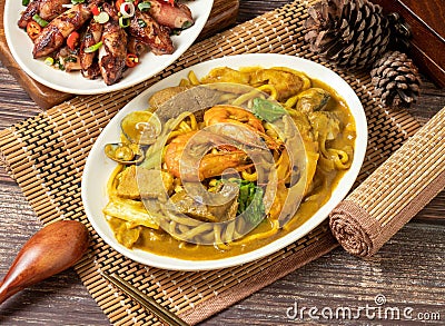 Curry Assorted Fried Noodles in a dish isolated on mat side view on dark wooden table taiwan food Stock Photo