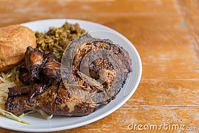 Jamaican curry goat, jerk chicken and fried dumpling Stock Photo