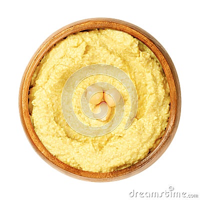 Curry hummus dip with chickpea garnish, in a wooden bowl Stock Photo