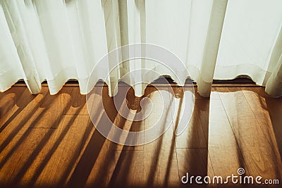 Curtain decorated beautifully in the room, Bright morning sun in the window through the curtains, White elegant curtains in a wood Stock Photo