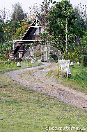 Curve dirt road to the countryside house Stock Photo