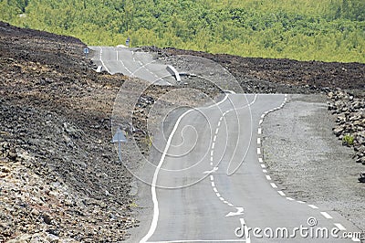 Curved asphalt road over volcanic lava, Reunion island, France. Stock Photo