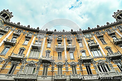 Curved baroque style residential building exterior view from below under cloudy sky Editorial Stock Photo