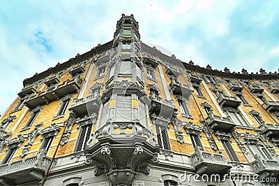Curved baroque style residential building exterior view from below under cloudy sky Editorial Stock Photo