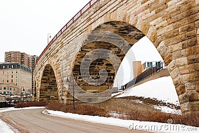 Curved Brick Arc and Iron bridge with road Stock Photo