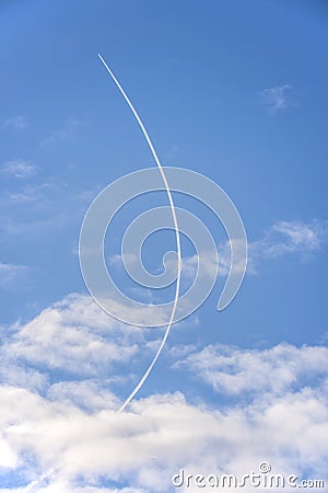 Curved contrail. Jet airliner plane flying at altitude leaving curving contrails Stock Photo