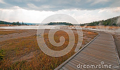 Curved Elevated wooden boardwalk going past Black Warrior Hot Springs and Tangled Creek into Hot Lake in Yellowstone National Park Stock Photo