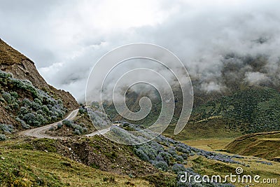 Curved mountain road in misty mountains, Abra Mariano Llamoja, pass between Yanama and Totora, The Choquequirao trek, Peru Stock Photo