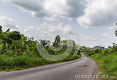 Curved and disappearing rural road Ekiti State Nigeria. Ekiti hills, disappearing road, Stock Photo