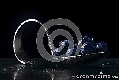 Curved spoon with blueberries Stock Photo