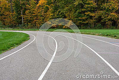 Curved sports track with autumn trees Stock Photo