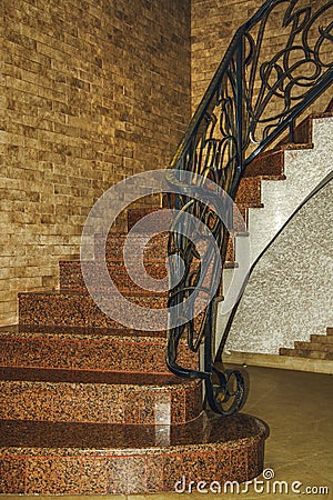 Curved stairs up with forged railing. Stair design. Stock Photo