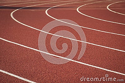 Curved white lines on a red rubber sports track Stock Photo