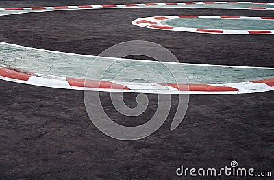 Curving asphalt red and white kerb of a race track detail Stock Photo