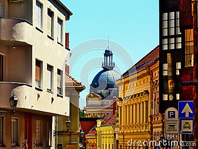 curving narrow alley. stucco exteriors. old historic residential street in Pecs, Hungary. Zink cupola and outlook Editorial Stock Photo