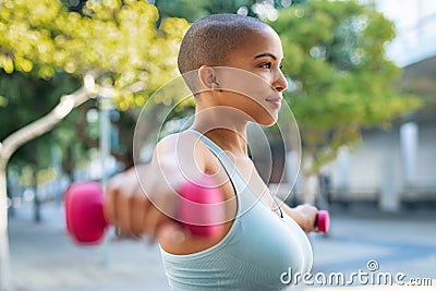 Curvy black woman using dumbbell Stock Photo