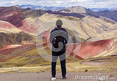 Cusco/Peru - Oct.03.19: boy admires the beautiful view on the Palccoyo rainbow mountains Editorial Stock Photo