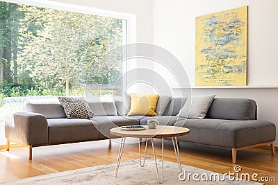 Cushions on grey corner couch in bright living room interior wit Stock Photo