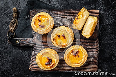 Custard Tarts Pasteis de Belem, Portuguese pastel de Nata. Black background. Top view Stock Photo