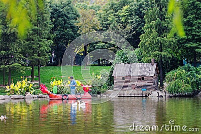 Custodian cleans a pond in public park Editorial Stock Photo