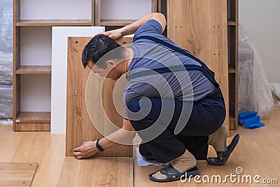 Custom furniture production and delivery man taking wooden planks for shelves Stock Photo