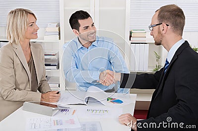 Customer appointment: business team with client making handshake Stock Photo