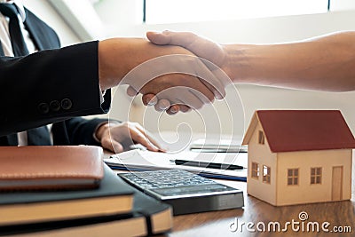 Customer and broker shake hands agreeing to buy new house at meeting after making sale purchase deal or finish buying or rental Stock Photo