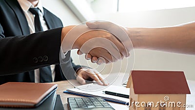 Customer and broker shake hands agreeing to buy new house at meeting after making sale purchase deal or finish buying or rental Stock Photo