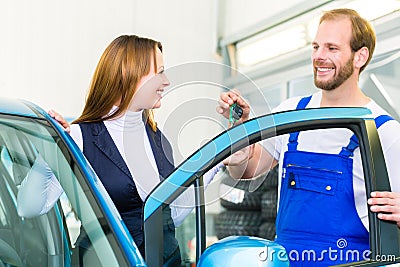 Customer and car mechanic in auto workshop Stock Photo