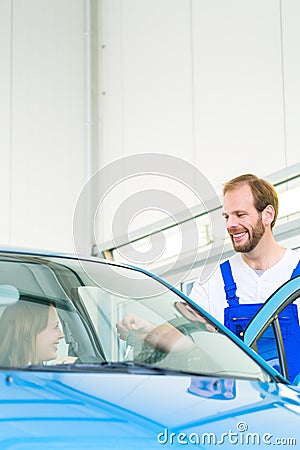 Customer and car mechanic in workshop Stock Photo