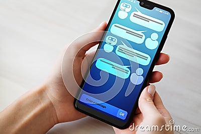 Customer and chatbot dialog on smartphone screen. AI. Artificial intelligence and service automation technology concept. Stock Photo