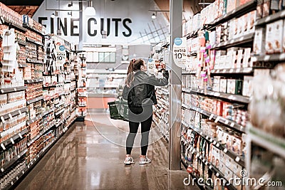 Customer choosing grocery products on display at Whole Foods Market in Oregon State Editorial Stock Photo