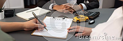 Customer client signs the contract with car dealer. Prodigy Stock Photo
