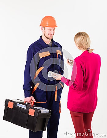 Customer give money to repairman, builder, mechanic with toolbox. Stock Photo