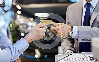 Customer giving credit card to car dealer in salon Stock Photo