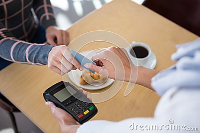 Customer giving credit card to waiter Stock Photo