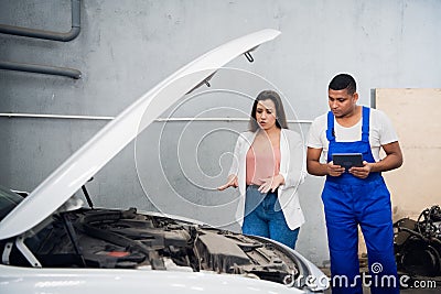 Customer hires a mechanic to repair a car Stock Photo
