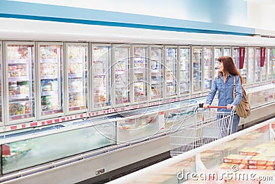 Customer looking for a product in the frozen aisle Stock Photo